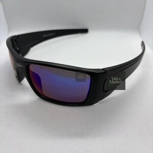 May include: Black sunglasses with reflective blue and purple lenses. The sunglasses have a rectangular shape and a thick frame. The text "Vista Market" is visible on the side of the frame.
