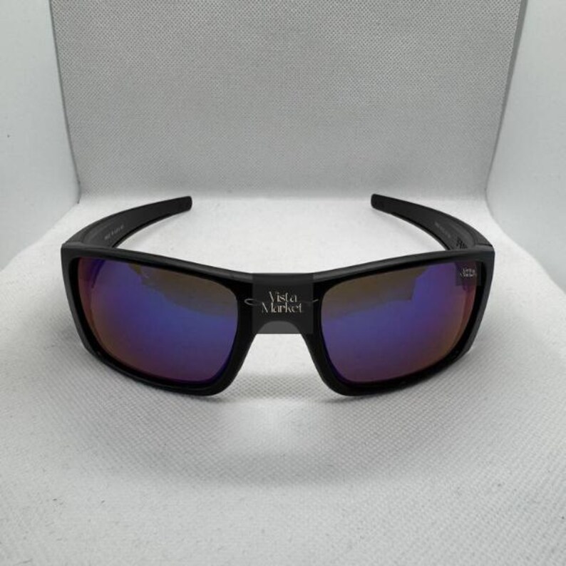 May include: A white ceramic mug with a black handle and the text "But First, Coffee" in a bold, black font. The mug is set against a blurred background, suggesting a cozy setting. The mug appears to be approximately 4 inches tall.