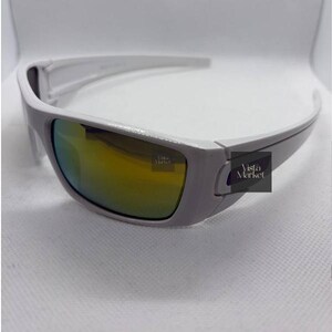 May include: A white ceramic mug with a black handle and the text "But First, Coffee" in a bold, black font. The mug is set against a blurred background, suggesting a cozy setting. The mug appears to be approximately 4 inches tall.