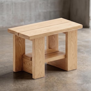 May include: A light-coloured wooden bench featuring a rectangular top composed of two parallel planks. The bench is supported by four thick, sturdy legs and includes a lower shelf constructed from two matching wooden planks, showcasing a natural grain.