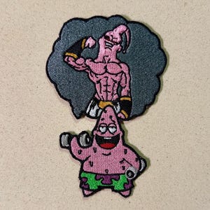 May include: Embroidered patch featuring two cartoon characters. The top character is pink with black accents, flexing its arm. The bottom character, also pink, is holding weights and wearing green shorts. Both characters are on a gray background.