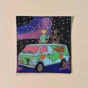 May include: Embroidered patch depicting the Mystery Machine van, with the text "THE MYSTERY MACHINE". The van is light blue and green with orange flower details. A boy and a dog are on top, under a starry night sky.