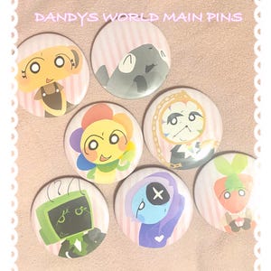 May include: Seven circular pins with cartoon illustrations. The pins feature a variety of characters in different colours. Text at the top reads "DANDYS WORLD MAIN PINS".