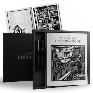 May include: A black box set containing The Bookish Coloring Book with a black and white cover illustration of a library, two black pens, and an open coloring book showing line art of a person in a library and a person in a bed.