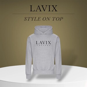 May include: A light gray hoodie with the text "LAVIX COUTURE" in black. The hoodie has a front pocket and a hood. The words "LAVIX" and "STYLE ON TOP" are also displayed in black. The hoodie is displayed on a white surface.