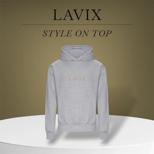 May include: A light gray hoodie with the word "LAVIX" in gold lettering on the chest. The hoodie has a drawstring hood and a kangaroo pocket. The text "STYLE ON TOP" is above the hoodie. The hoodie is displayed on a white surface.