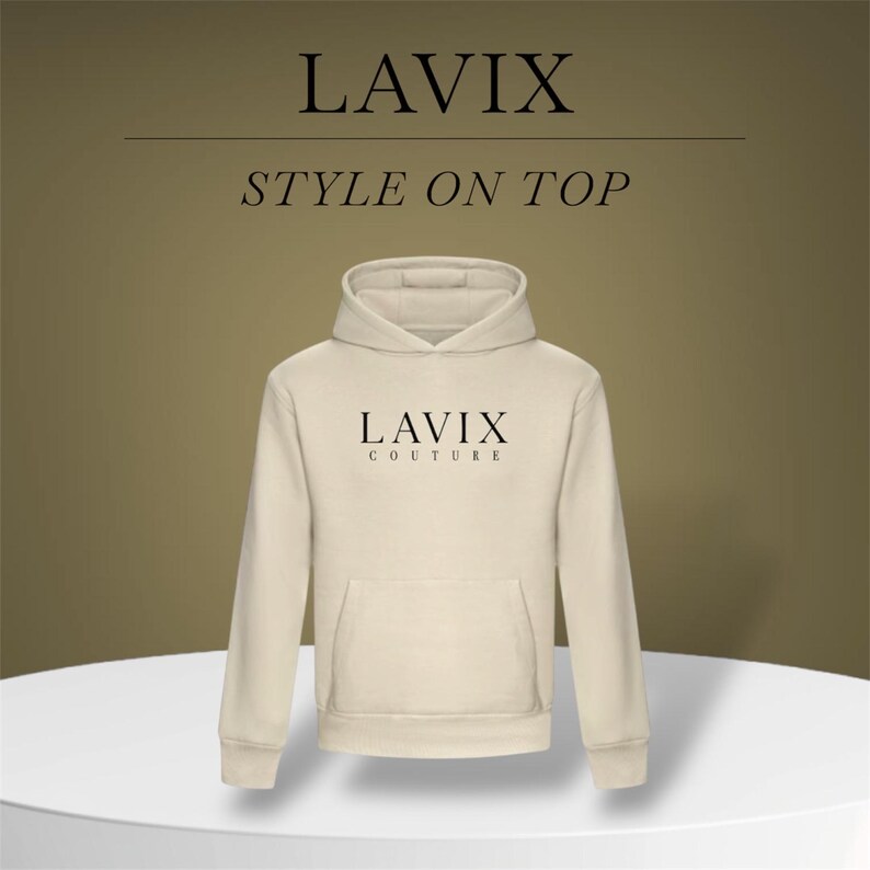 May include: Cream-colored hoodie with the text "LAVIX" and "STYLE ON TOP" in black. The hoodie has a front pocket and a hood. The brand name "LAVIX COUTURE" is printed on the chest.