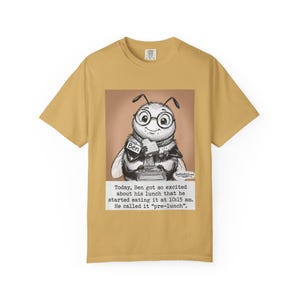 May include: Mustard yellow t-shirt featuring a sepia-toned illustration of a bee wearing glasses and a name tag that says "Ben." The bee is holding a sandwich. Text below reads: "Today, Ben got so excited about his lunch that he started eating it at 10:15 am. He called it 'pre-lunch.'"