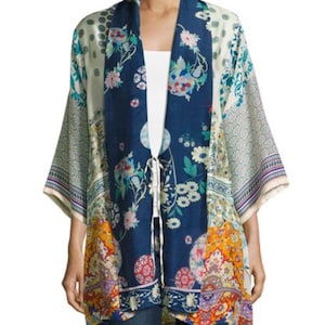 May include: A colorful kimono-style jacket with a floral pattern in shades of blue, white, orange, and purple. The jacket has wide sleeves and a tie closure at the waist. The garment is made of a lightweight fabric.