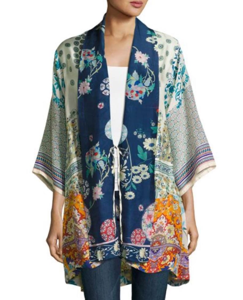 May include: A colorful kimono-style jacket with a floral pattern in shades of blue, white, orange, and purple. The jacket has wide sleeves and a tie closure at the waist. The garment is made of a lightweight fabric.