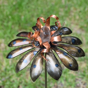 3D flower metal sculpture with 12 heat treated petals & copper stamen wrapping holding a quartz crystal  center - created by Arthur Schoenig