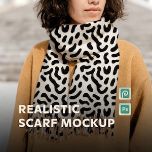 May include: A cream-colored scarf with a black organic pattern is draped around a person's neck. The scarf has a fringed edge and the text "REALISTIC SCARF MOCKUP" is displayed at the bottom. The person is wearing a mustard-colored sweater.
