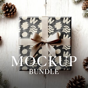 May include: A wrapped gift box with a black and cream abstract pattern, tied with a beige ribbon and bow. The text "MOCKUP BUNDLE" is displayed on the front. Pinecones and greenery surround the box.