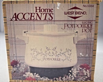 Potpourri eléctrico West Bend Home Accents, modelo 53614, en su caja original.