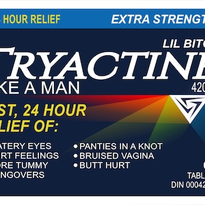 May include: A dark blue label with white text that reads "TRYACTINE LIKE A MAN" and "EXTRA STRENGTH". The label lists symptoms such as watery eyes and sore tummy. It also includes the text "420mg" and "69 tablets".