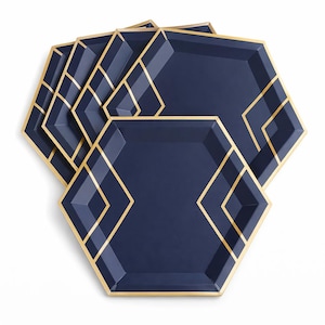 May include: A set of navy blue hexagonal paper plates with gold geometric accents. The plates have a gold trim and a diamond-shaped design in the center. These plates are suitable for a party or special event.