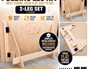 May include: A folding leg kit for backdrops and signs, featuring a 2-leg set made of light-colored plywood. The kit includes black metal hinges and screws for installation. The legs are designed to fold flat for storage and support upright panels.