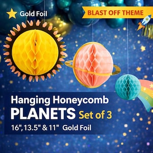 May include: Set of three hanging honeycomb planets in gold foil. The planets are yellow, coral, and teal, with sizes of 16, 13.5, and 11 inches. The background features a space theme with stars and a rainbow.