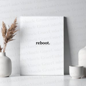 May include: A white canvas print with the word "reboot." in black. The print is displayed on a white surface, accompanied by a vase with dried plants and two white ceramic vessels.