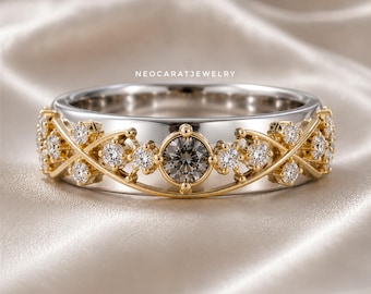 May include: A silver-toned band ring featuring a central dark grey round-cut stone surrounded by smaller clear round-cut stones set in a yellow gold-toned crisscross lattice design. The text NEOCARATJEWELRY is printed above the ring.
