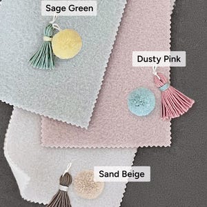 color options for baby milestone signs: sage green, dusty rose pink, sand beige with matching tassels and pompom. soft pastel color tones that are gender-neutral which make it perfect for gender reveal party, baby shower gift, and newborn arrival gift.