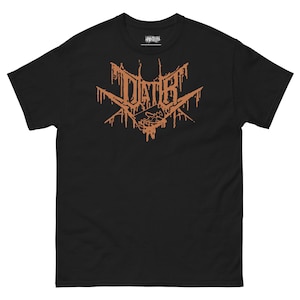 May include: Black t-shirt with a distressed orange graphic. The design features the word "DIATH" in a stylized font, with dripping effects and a geometric shape. The shirt is made of a soft material and has a classic crew neck.