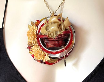 Sailing ship narrative assemblage brooch, pendant necklace, celluloid measuring tape, upcycled vintage jewelry, Coca-Cola can, lightweight