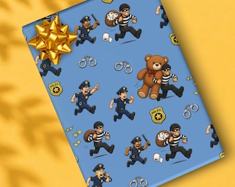 May include: Light blue wrapping paper featuring a repeating cartoon pattern of police officers chasing burglars in striped shirts. The design includes handcuffs, gold police badges, rolls of toilet paper, and a brown teddy bear. A gold gift bow is attached.