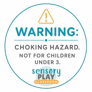 May include: A circular sticker with a teal border featuring a yellow warning triangle icon. The text reads: WARNING: CHOKING HAZARD. NOT FOR CHILDREN UNDER 3. Below this, the logo reads: sensory PLAY CLASSROOM in teal, gray, and orange text.