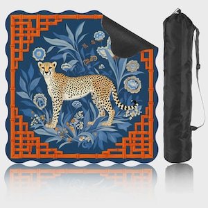 May include: A yoga mat featuring a cheetah design. The mat has a blue background with floral and bamboo-style orange accents. A black carrying bag is included. The cheetah is tan with black spots.