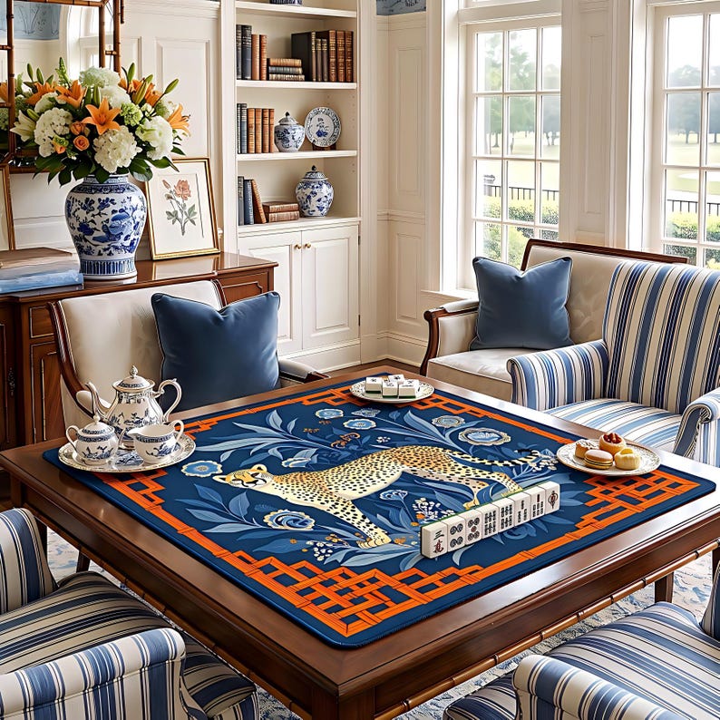 May include: A wooden game table with a blue and orange patterned mat featuring a cheetah design. The table is set with a mahjong set, tea set, and snacks. The room has a classic, elegant style.