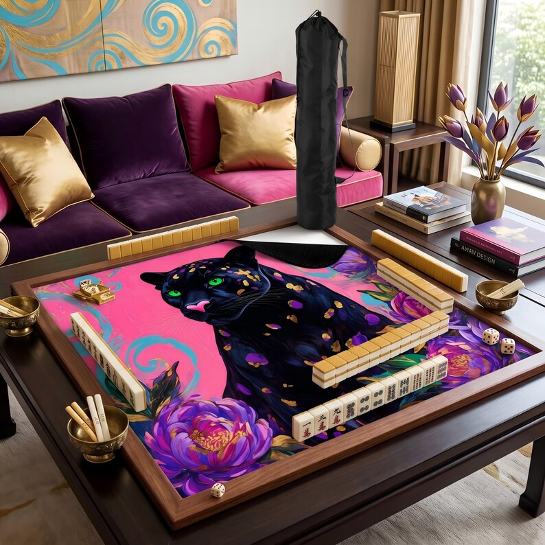 May include: A wooden Mahjong set with a pink playing surface, featuring a black panther illustration with green eyes and purple spots. The set includes tiles, dice, and a black carrying bag.