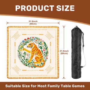 Peut inclure: Tapis de jeu beige avec une illustration de tigre, entour&eacute; de fleurs et de texte. Le tapis mesure 80 cm de c&ocirc;t&eacute; et est livr&eacute; avec un sac de transport noir. Le texte indique "PRODUCT SIZE" et "Suitable Size for Most Family Table Games."