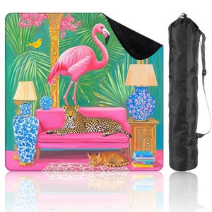 May include: A vibrant beach blanket featuring a pink flamingo, leopard, and cat lounging on a pink sofa. The design includes a tropical scene with lamps, a bird, and a black carrying bag. The blanket is perfect for outdoor use.