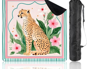May include: A yoga mat featuring a cheetah design with pink flowers and green leaves. The mat has a pink and green border and comes with a black carrying bag. The cheetah is tan with black spots.