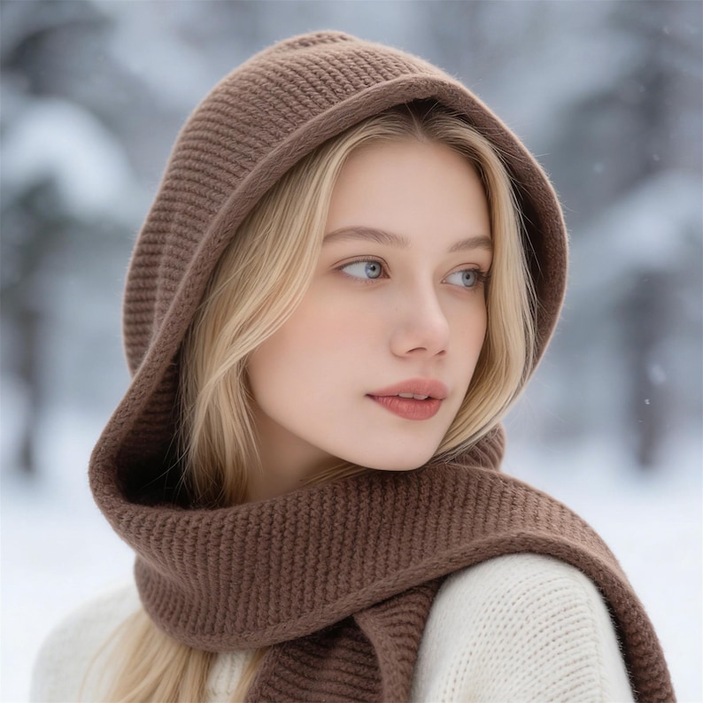 May include: A brown knit hood and scarf set. The hood is designed to be worn over the head, with a scarf that can be wrapped around the neck. The set is made of a soft, textured knit material, perfect for cold weather.