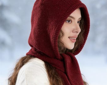 May include: A burgundy knit hood and scarf set. The hood is designed to cover the head and neck, with a scarf that drapes down the front. The set is made of a thick, warm material, perfect for cold weather.