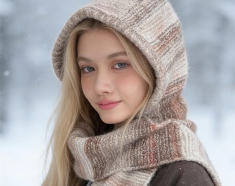 May include: A hooded scarf featuring a ribbed knit texture in a variegated color palette of beige, cream, and soft brown tones. The accessory includes an integrated hood that transitions into a long scarf, crafted from a soft, textured yarn.