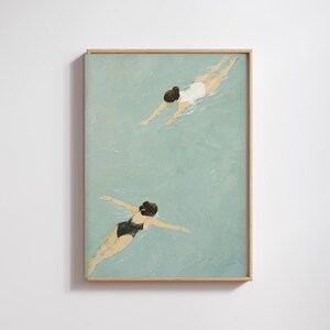 May include: A framed painting depicting two figures swimming in light blue water. One figure wears a white swimsuit and the other wears a black swimsuit. The artwork features visible brushstrokes and is encased in a light-coloured wooden frame.