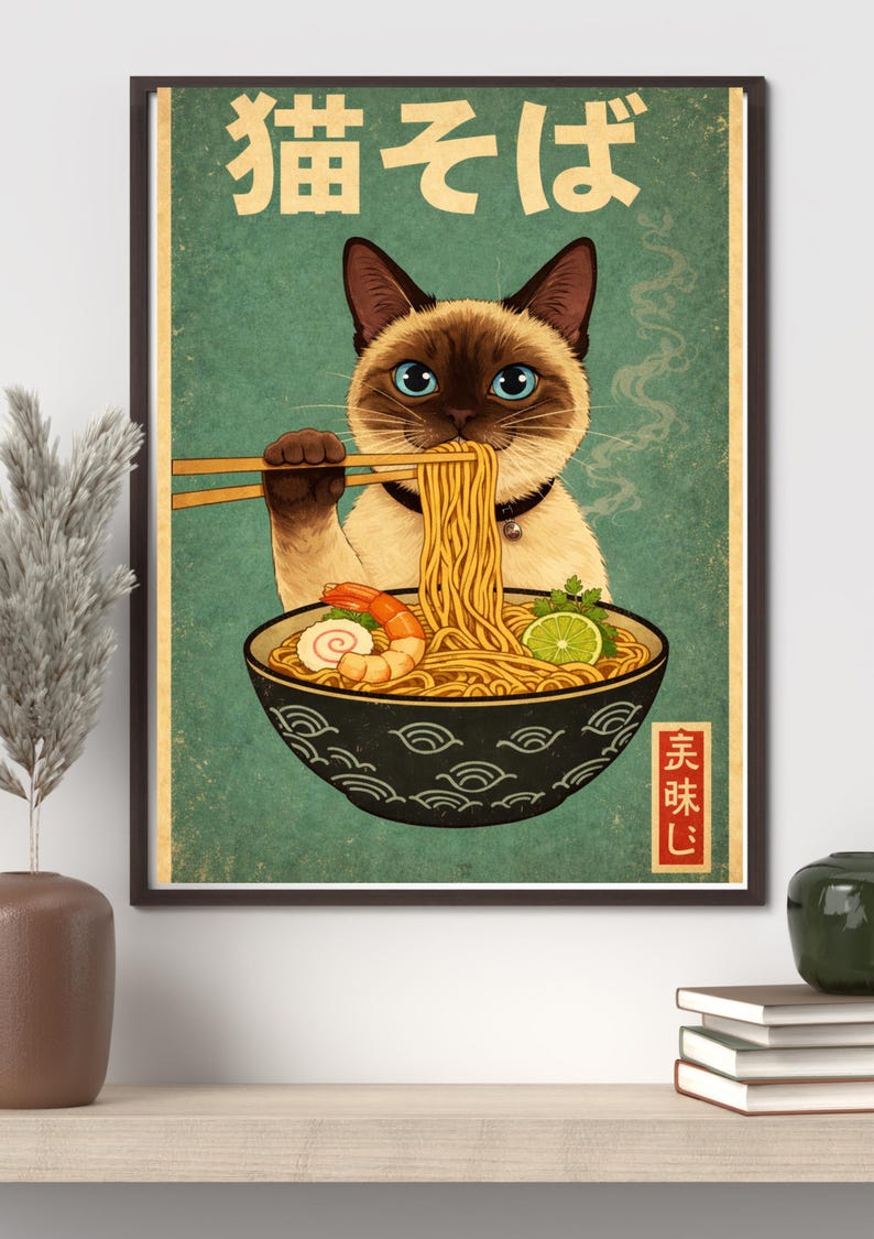 May include: A framed vintage-style poster featuring a Siamese cat enjoying ramen. The cat, with blue eyes, holds chopsticks with noodles. The bowl contains shrimp, lime, and other ingredients. Japanese text is at the top and bottom.
