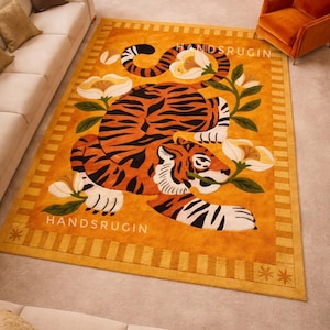 9x12 Large Tiger Area Rug in Vibrant Orange and Gold Wool for Living Room Decor.
 * Hand-Tufted Animal Print Rug featuring Black and White Tiger with Floral Accents 9x12.
 * Luxury 100% Wool Gold Rug with 3D Hand-Carved Tiger Design for Modern Homes.
 * Artisan Hand-Made 9x12 Orange Rug with Tropical Flower and Tiger Pattern.
 * HandsRugsIN Large Statement Rug in Saffron Wool with Jungle Theme Artwork.
 * Close-up of Hand-Tufted Wool Texture on 9x12 Orange Tiger Motif Rug.