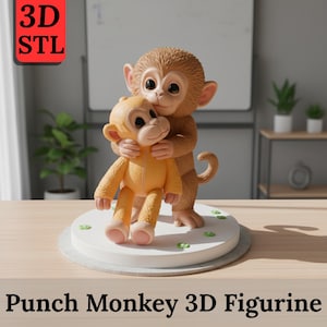 May include: A 3D-printed figurine of two monkeys. One larger brown monkey hugs a smaller yellow monkey. The figurine sits on a white circular base with green accents. The text "Punch Monkey 3D Figurine" is at the bottom.