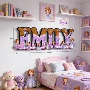May include: A wall-mounted decorative name sign spelling EMILY in large, purple and brown patterned letters featuring Sofia the First character graphics. The sign includes dimension markers indicating a height of 46 inches and a width of 46 inches.