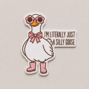 May include: An embroidered patch featuring a white goose wearing pink flower-shaped sunglasses, a pink bow tie, and pink polka-dot rain boots. To the right of the goose, a speech bubble contains the brown text: I'M LITERALLY JUST A SILLY GOOSE.