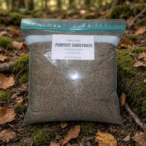 May include: A clear plastic resealable bag filled with a brown granular substrate. A white label on the front reads OrganicCrabby PERFECT SUBSTRATE 1:5 Play Sand / Eco Earth for Land Hermit Crabs NET WT 10 lb (4.54 kg) in black text.