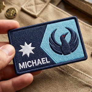 May include: A white ceramic mug with a black handle and the text "But First, Coffee" in a black, handwritten-style font. The mug is on a white surface.