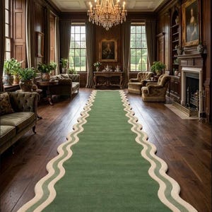 May include: A long, green rug with a wavy, cream-colored border is the focal point of a room with dark wood paneling and a chandelier. The rug's design adds a unique touch to the classic interior. The room also features large windows and antique furniture.