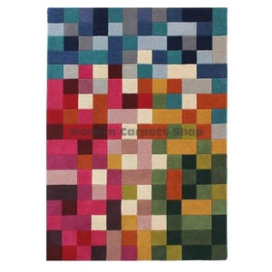 May include: A rectangular area rug with a colorful pixelated design. The rug features a mosaic of squares in shades of blue, pink, red, green, yellow, and brown. The text "Modern Carpets Shop" is visible in the lower center.
