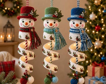 May include: Three hanging crochet snowman ornaments with red, green, and blue hats and matching scarves. Each snowman features a white head with a carrot nose, a spiral body with holly embroidery, and a small wooden button on the scarf.