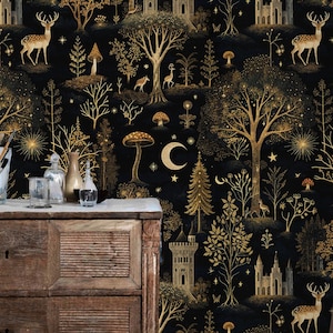 May include: Black and gold forest-themed wallpaper featuring trees, castles, deer, and crescent moons. The wallpaper has a repeating pattern with a vintage aesthetic. The image also shows a wooden dresser and a chair.